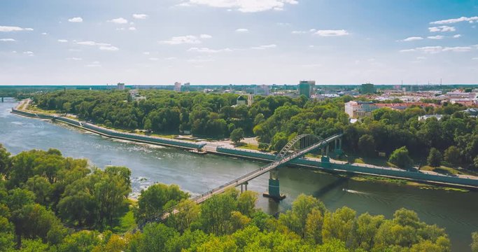 Flying over the city park and river in the city of Gomel with a view of the church deep in the trees.