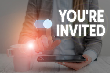 Handwriting text You Re Invited. Conceptual photo Please join us in our celebration Welcome Be a guest Woman wear formal work suit presenting presentation using smart device