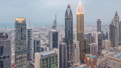 Skyline of the buildings of Sheikh Zayed Road and DIFC aerial day to night timelapse in Dubai, UAE.