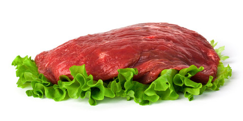Fresh raw meat with green salad isolated on white background