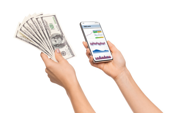 Trading app opened on smartphone and cash in female hands