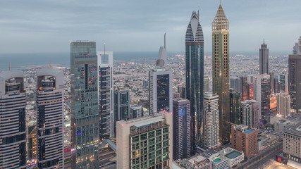 Skyline of the buildings of Sheikh Zayed Road and DIFC aerial night to day timelapse in Dubai, UAE.