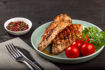 Tasty grilled chicken with fresh tomatoes on a dish