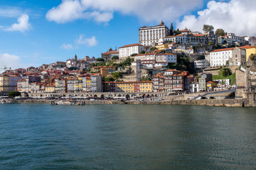 Naklejka premium View of Porto across the Douro River from the opposite river bank with historic centre in the distance