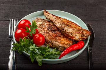Tasty grilled chicken with fresh tomatoes on a dish