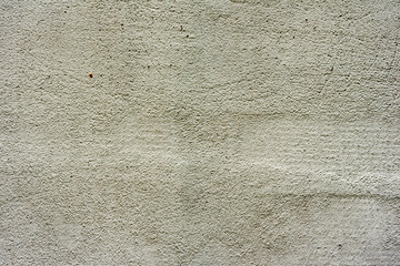 Texture of a concrete wall with cracks and scratches which can be used as a background