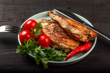Tasty grilled chicken with fresh tomatoes on a dish