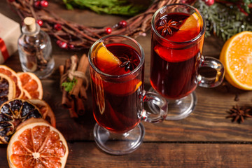 Christmas hot mulled wine with cinnamon cardamom and anise on wooden background