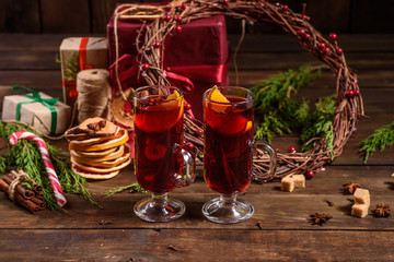 Christmas hot mulled wine with cinnamon cardamom and anise on wooden background