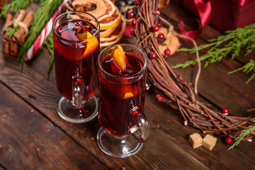 Christmas hot mulled wine with cinnamon cardamom and anise on wooden background