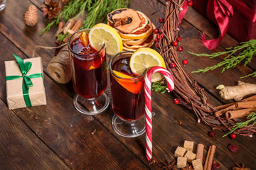 Christmas hot mulled wine with cinnamon cardamom and anise on wooden background