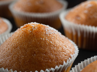 some juicy tasty muffins stuffed cupcakes. dark background