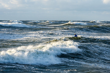 Surfer in the waves (Klaipeda, Lithuania)