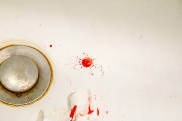Real drops of blood fallen on a sink. Horror Background for usage in mixed media content.
