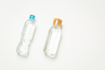 plastic and glass bottles for water on a white background