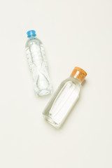 plastic and glass bottles for water on a white background