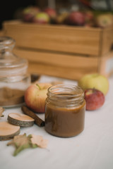 Homemade salty brown liquid caramel. Homemade soft caramel made from sugar on a background of apples and pumpkins