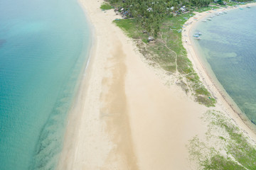 A narrow isthmus with a clean white sand beach and some dunes