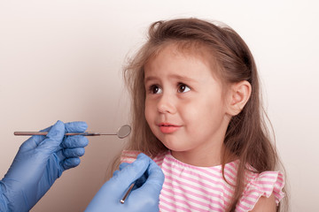 Dental medicine and healthcare - dentist examining little child girl patient open mouth showing...