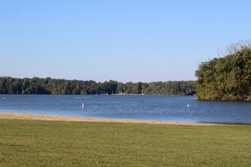 A view of the beautiful lake from the shore on sunny day.
