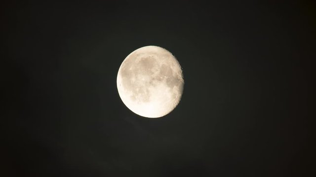 Detailed bright almost full moon close up moving behind clouds time lapse.mov