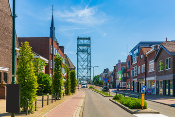 Old houses and vertical lift bridge crossing the river Gouwe at the picturesque village Boskoop,...
