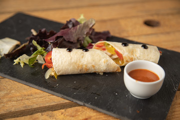 delicious vegan roll on black slate plate