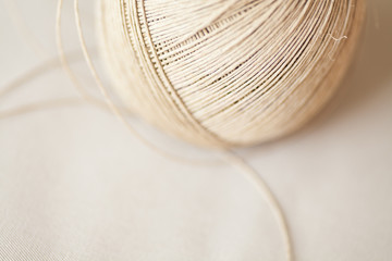 Twine shot in natural light with shallow depth of field as abstract background or design and object detail in light tan or beige color