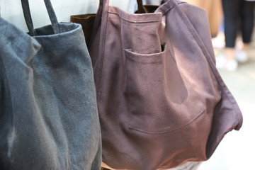 Closeup of woman's reusable cotton bags showing at the shop.