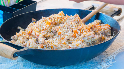 Close up shot of pilaf dish at street food festival. Outdoor cooking, gastronomy, takeaway food and service concept