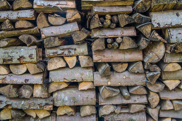 Wooden firewood are stacked on top of each other.