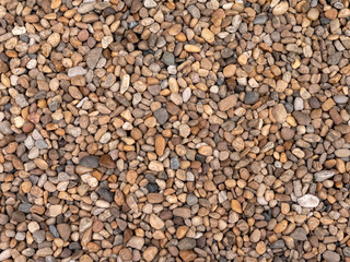Background, small sea pebbles of brown and black tint