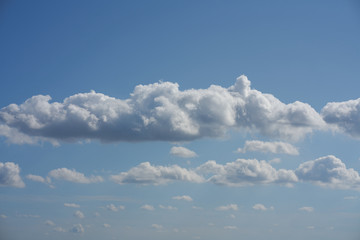 Huge clouds in the blue sky as background. beautiful white cloud formation in bright blue sky as background