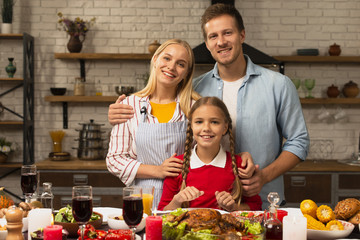 Happy family smiling and looking at the camera