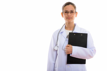Studio shot of young beautiful woman doctor holding clipboard