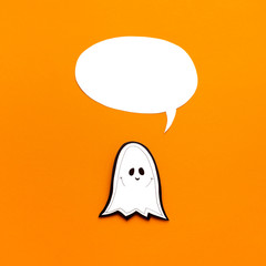 Smiling paper ghost with empty speech bubble for tag
