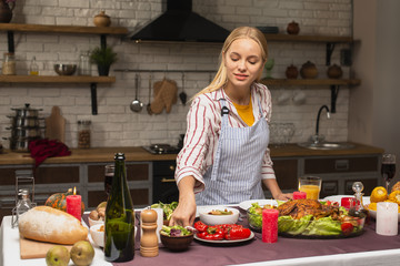 Long shot of woman arranging food in the kitchen