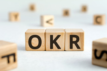 OKR - acronym from wooden blocks with letters, abbreviation OKR Objectives and Key Results concept,...