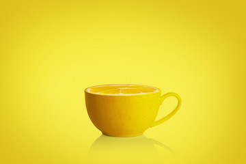 Cup of tea with mint and lemon on yellow background