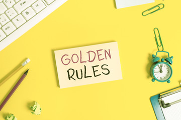Handwriting text Golden Rules. Conceptual photo basic principle that should always follow to ensure success Flat lay above copy space on the white crumpled paper