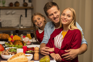 Husband hugging his wife in the kitchen