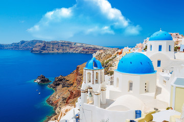 Fototapeta na wymiar Panoramic shot of the Blue domed church at Oia Santorini Greece