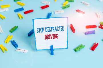 Conceptual hand writing showing Stop Distracted Driving. Concept meaning asking to be careful behind wheel drive slowly Colored clothespin papers empty reminder blue floor officepin