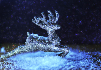 Obraz na płótnie Canvas Christmas glitter deer on violet sparkling background. Neon light. Christmas concept.