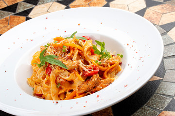 Duck fettuccine with cherry tomatoes in red sauce