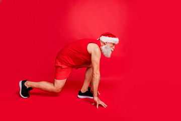 Ready steady go. Full length profile side photo of focused santa claus ready to run race wearing...