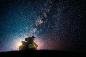 Couple love teddy bear (non branded) hugging on starry night sky, love concept	