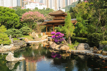 Fototapeta na wymiar The oriental pavilion in Nan Lian Garden with many building background,Kowloon, Hong Kong. Chi Lin Nunnery is a tourist attraction.