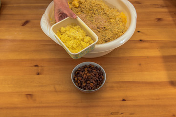 On a wooden table are all the ingredients for a Christmas stollen. These are given in a bowl. Concept: Christmas and baking