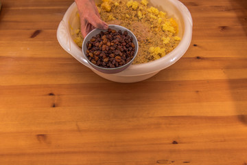On a wooden table are all the ingredients for a Christmas stollen. These are given in a bowl. Concept: Christmas and baking